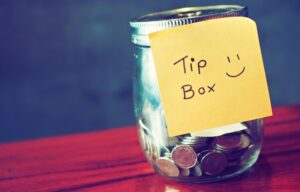 A tip jar with a post-it note that says "tips here" for investing tips.