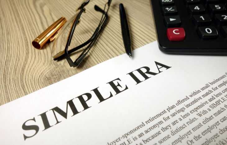 The definition of a SIMPLE IRA plan sitting on a desk