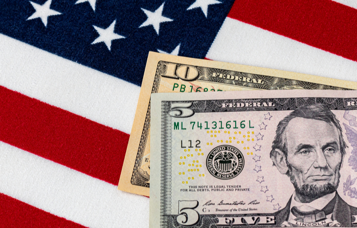 $15 minimum wage sitting on the American flag