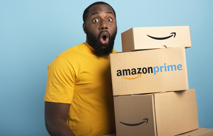 Amazon stock forecast man holding Amazon packages